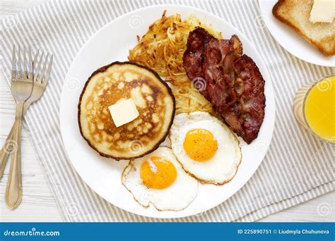 Full American Breakfast With Bacon Hash Browns Eggs And Pancakes On A