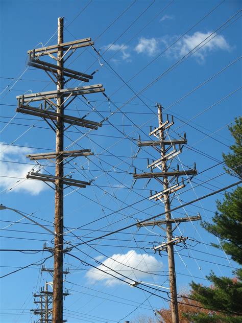 Many Telephone Poles And Wires Against A Blue Sky