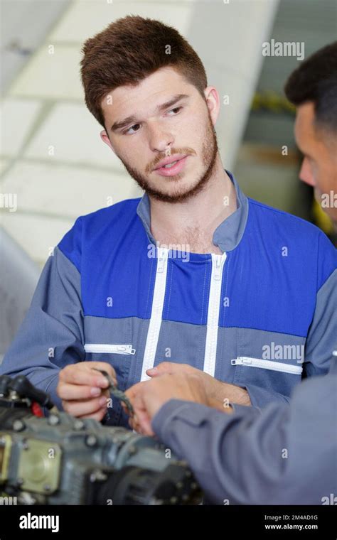 Apprentice Mechanic In Auto Shop Working On Car Engine Stock Photo Alamy