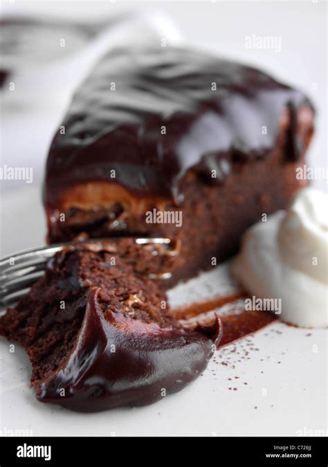 Chocolate fudge cake slice Stock Photo - Alamy