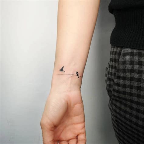 Tiny Birds on Wrist Tattoo by Michał Sukiennik