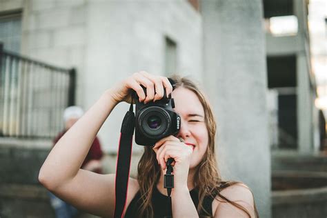 HD wallpaper: woman holding black DSLR camera, woman holding black Canon DSLR camera taking ...