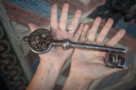 Closeup Of Hands Holds Old Large Huge Massive Metal Key Stock Photo