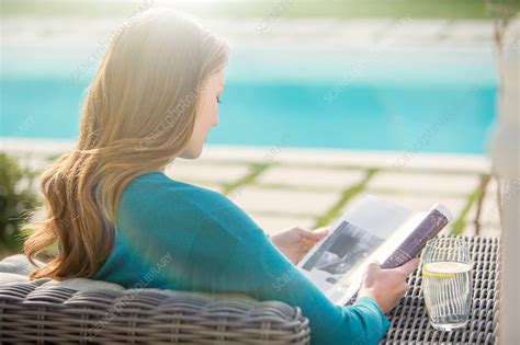 Brunette Woman Reading Magazine Stock Image F Science Photo Library
