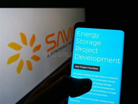 Person Holding Smartphone With Webpage Of American Solar Energy Company