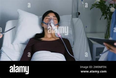 Panning Shot Of A Young Asian Female Patient Lying Unconscious In