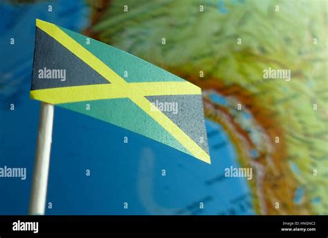 Jamaica Flag With A Globe Map As A Background Macro Stock Photo Alamy