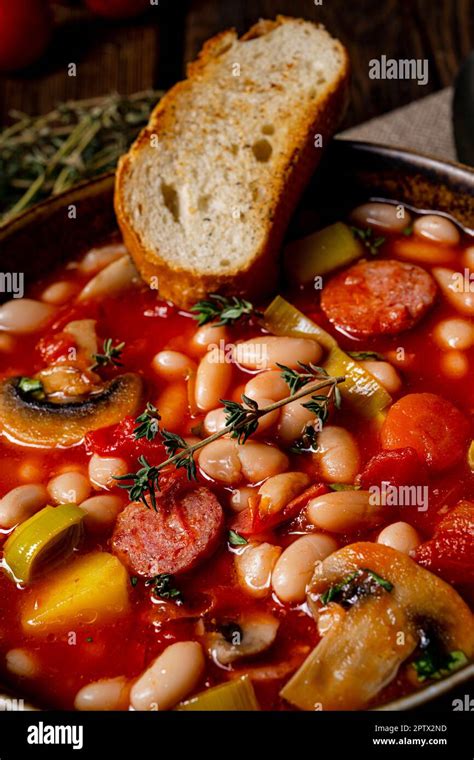 Rustic Bean Soup With Potatoes And Sausages Stock Photo Alamy