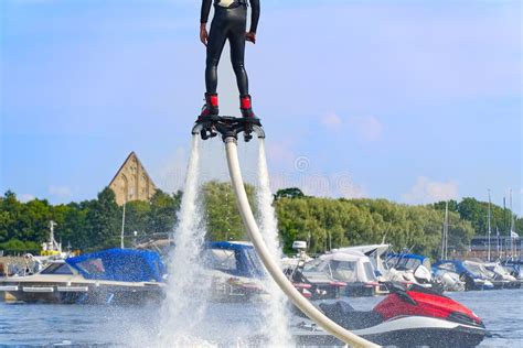 Man Having Fun On Flyboard Flyboarding In A Sunny Summer Day At River