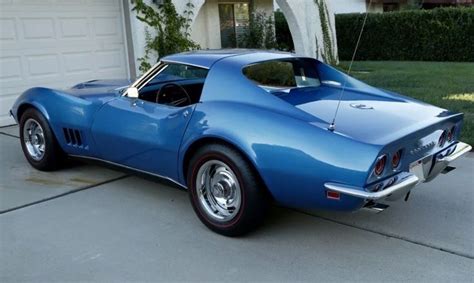 A Blue Sports Car Parked In Front Of A House