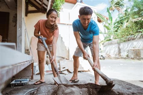Premium Photo Newly Married Women And Men Make Cement Mix Using