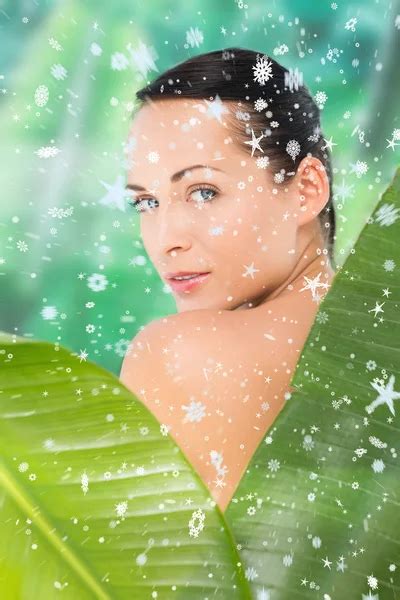 Beautiful Nude Brunette Posing With Green Leaves Stock Photo Wavebreakmedia