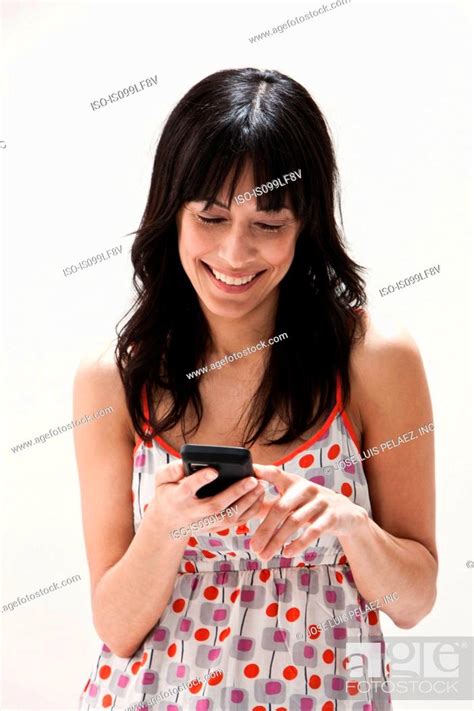 Smiling Mature Woman Using Cellphone Studio Shot Stock Photo Picture And Royalty Free Image