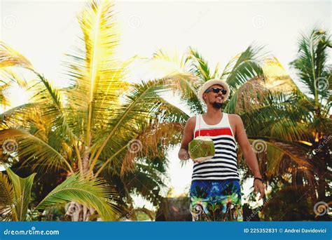 Man With Coconut On The Tropical Beach On Sunny Summer Day During