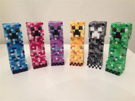 Six Different Colored Bracelets Made Out Of Perler Beads On A White Table Top