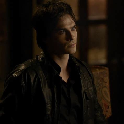 A Man In A Black Shirt And Leather Jacket Looking Off Into The Distance