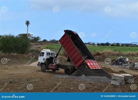 Dump Truck Dumping Black Sand on a Fresh Work Site Stock Photo - Image ...