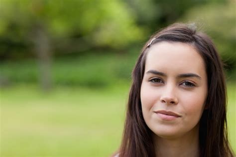 Premium Photo Young Calm Woman Standing Upright In A Parkland