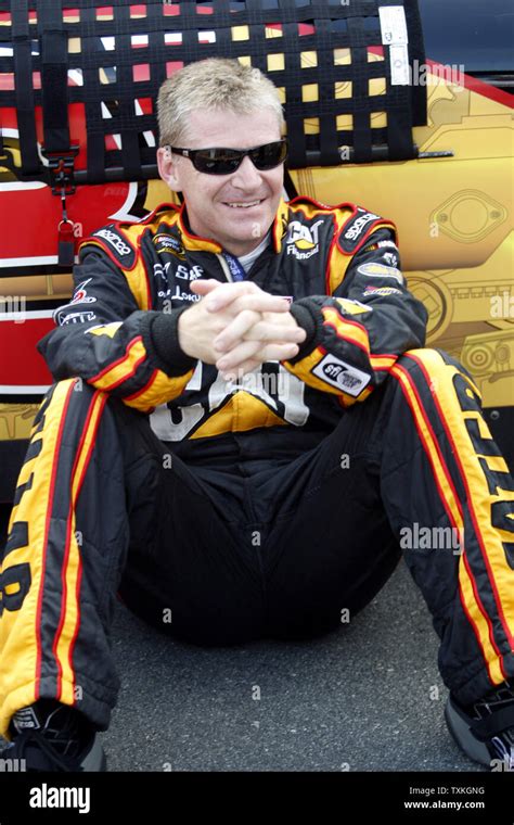 Race Car Driver Jeff Burton Sits By His Car On Pit Road Before The