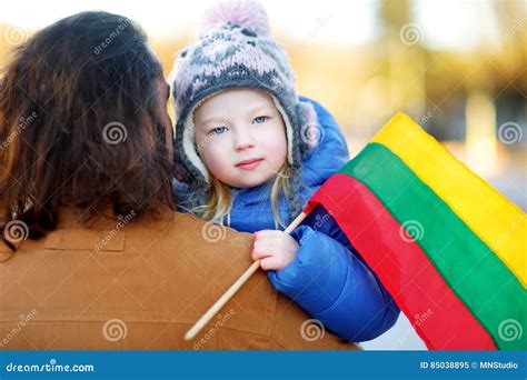 Father and Daughter with a Flag on Lithuanian Independence Day Holding ...