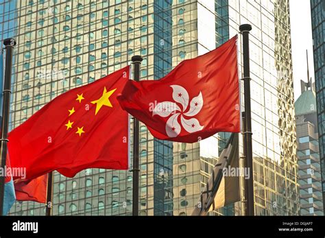 Flags of China and Hong Kong in front of an office building, Hong Kong, Hong Kong, China, People ...