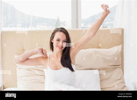 Pretty Brunette Stretching In Bed Stock Photo Alamy