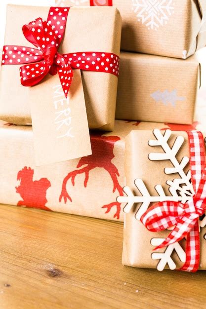 Premium Photo Christmas Gifts Wrapped In Brown Paper With Red Ribbons