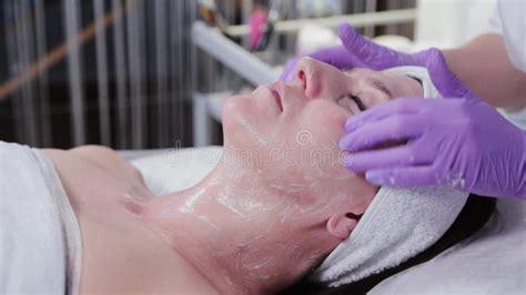 Woman Beautician Doing Facial Massage To Young Woman Stock Footage