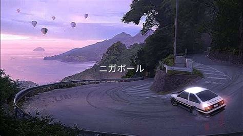 A Car Driving Down A Winding Road Next To The Ocean With Hot Air