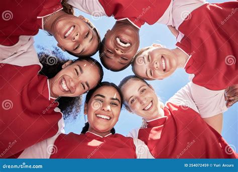 Female Soccer Team In A Huddle Smiling In Unity And Support In A Circle