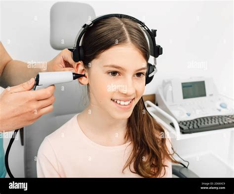 Audiologist Is Doing A Hearing Exam On A Girl Impedance Audiometry