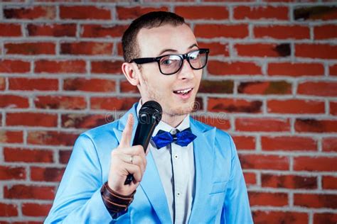 A Man Actor Comedian In Glasses A Stylish And Tie Suit Holds A