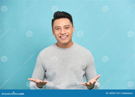 Young Happy Handsome Asian Man Raising His Hands With Open Palms