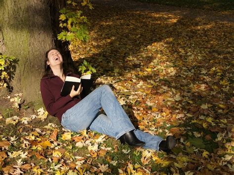 Premium Photo Woman Laughing Out Loud While Reading A Book