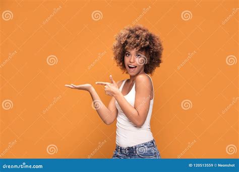 Cheerful Afro Woman Points Her Fingers On Yellow Background Stock Image Image Of Black