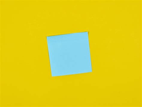 Blank Blue Square Adhesive Labels On A Yellow Backdrop Photo Background