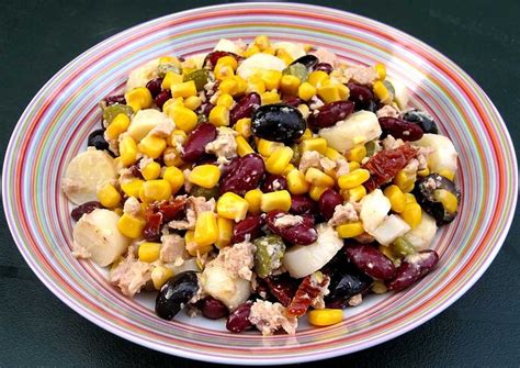 A Bowl Filled With Fruit And Vegetables On Top Of A Black Tablecloth