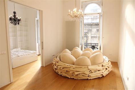 The Giant Birdnest A Cozy Wooden Bed Filled With Egg Shaped Pillows