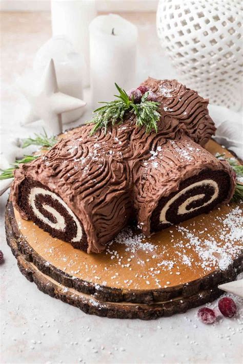 There Is A Chocolate Cake With Icing On The Top And Some Cranberries