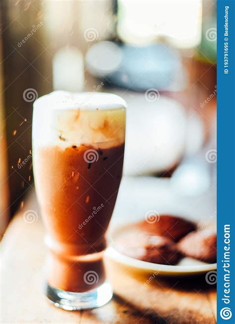 Iced Cocoa Drink With Whipped Cream And Brownie Cookies On Wood Table