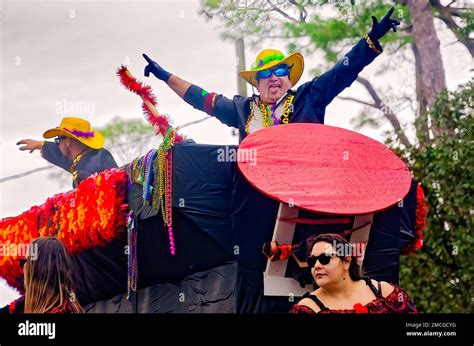 Members Of Krewe De La Dauphine Ride A Mardi Gras Float During The