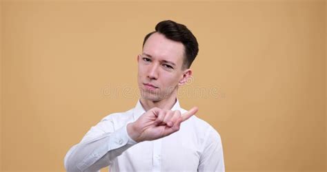 Serious Caucasian Shaking Finger On Denial On Beige Background Stock