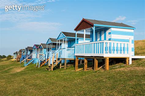 Colourful Wooden Beach Huts Facing The Ocean At Whitstable Coast Kent