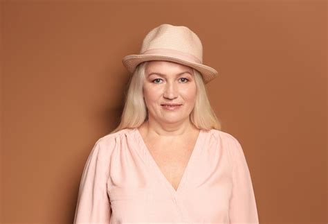 Premium Photo Portrait Of Beautiful Mature Woman On Color Background