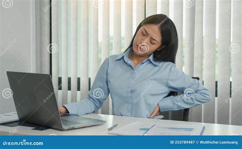 Asian Woman Who Sits At Work For A Long Time Has Back Pain While