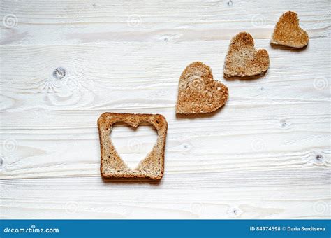 Toast With Cut Out A Heart Inside And Three Small Hearts Of White Bread