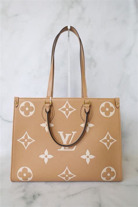 Louis Vuitton Onthego Mm Arizona Beige And White Empreinte Leather