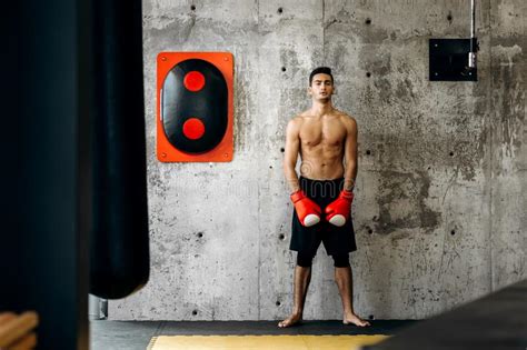 Brutal Dark Haired Guy With A Naked Torso And The Red Boxing Gloves