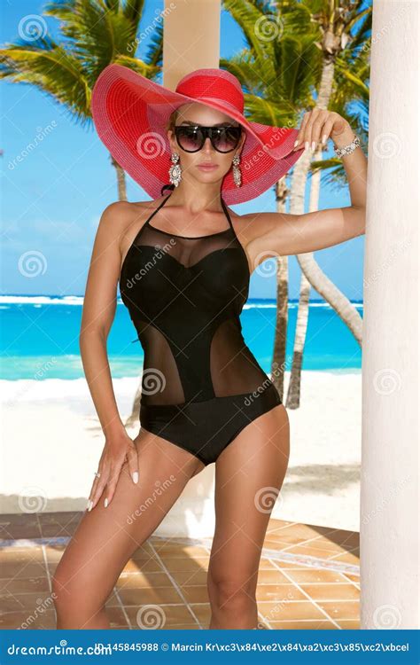 Beautiful Woman In Bikini And Hat Posing On The Caribbean Beach Stock