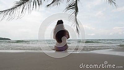 Asian Woman In Bikini Posture With Coconut Palm Leaf On Tropical Beach